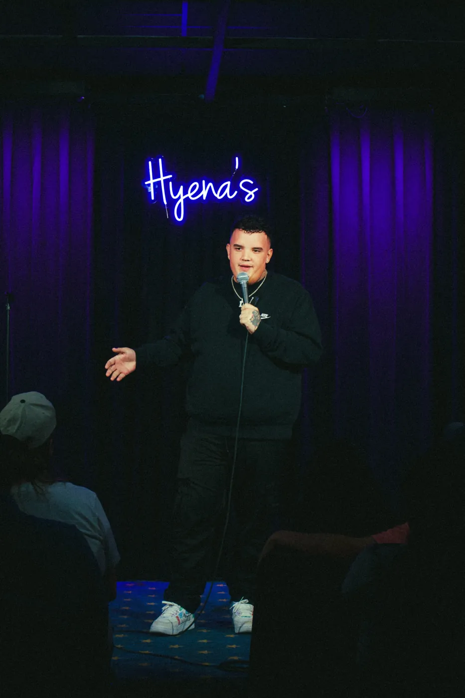 AJ Deleon on stage, Hyena's Comedy Club